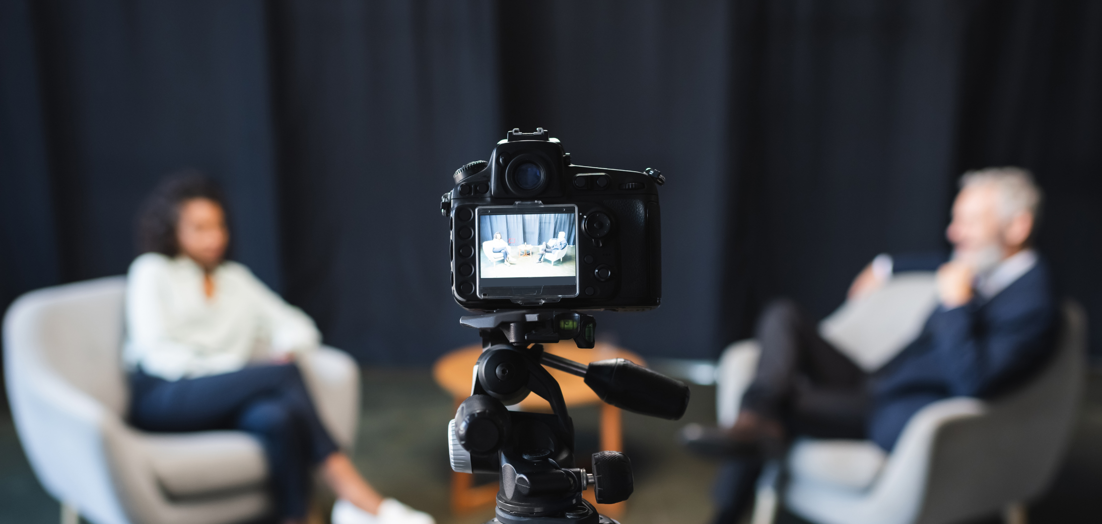 digital camera with a journalist interviewing a businessman with a camera recording