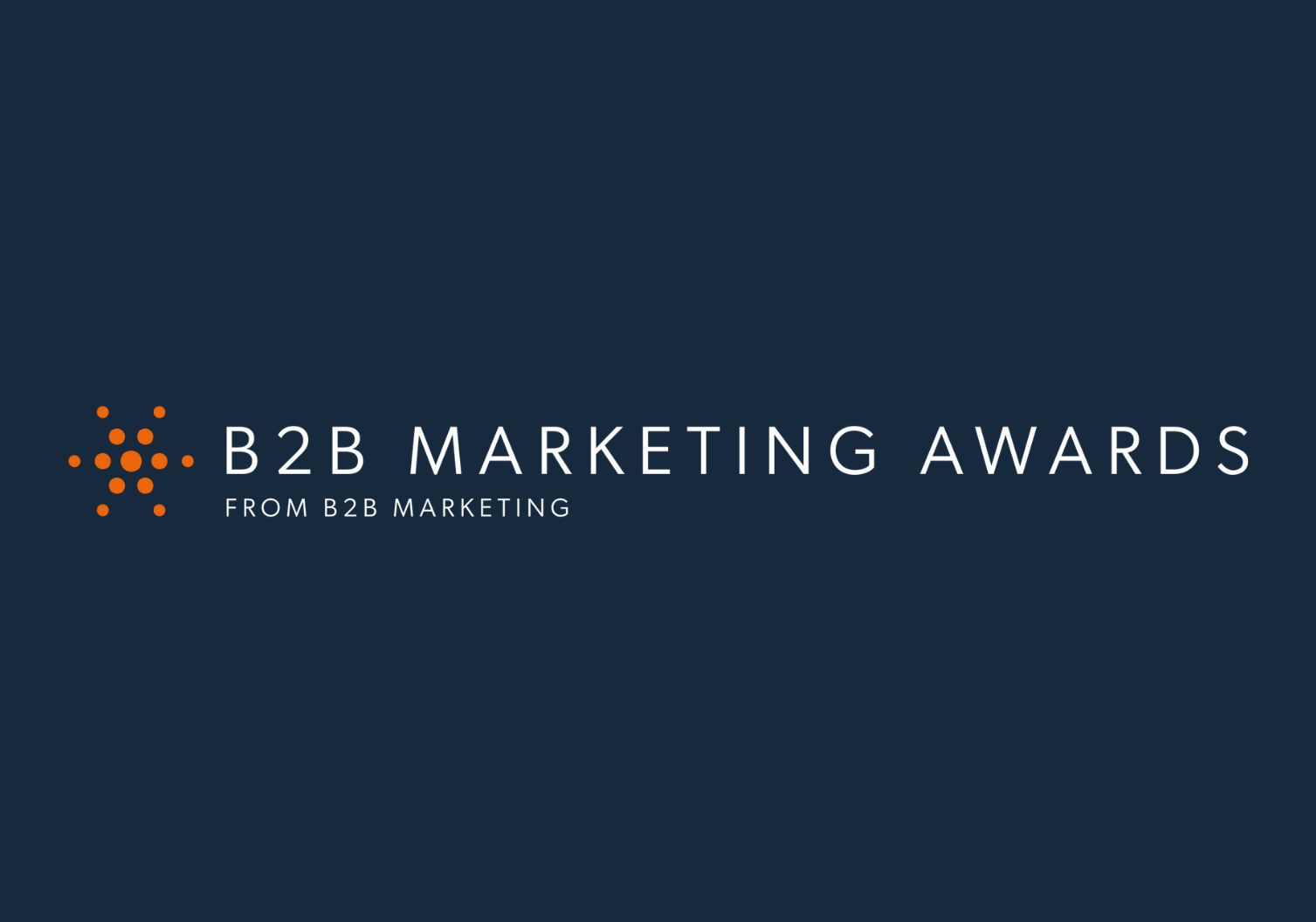 B2B marketing awards graphic logo in white and orange on a blue background