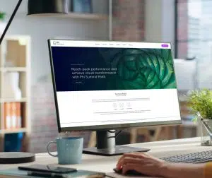 Phi Partners' Peak Performance campaign imagery showcasing the website home page for Summit PaaS on a desktop PC in a modern office.