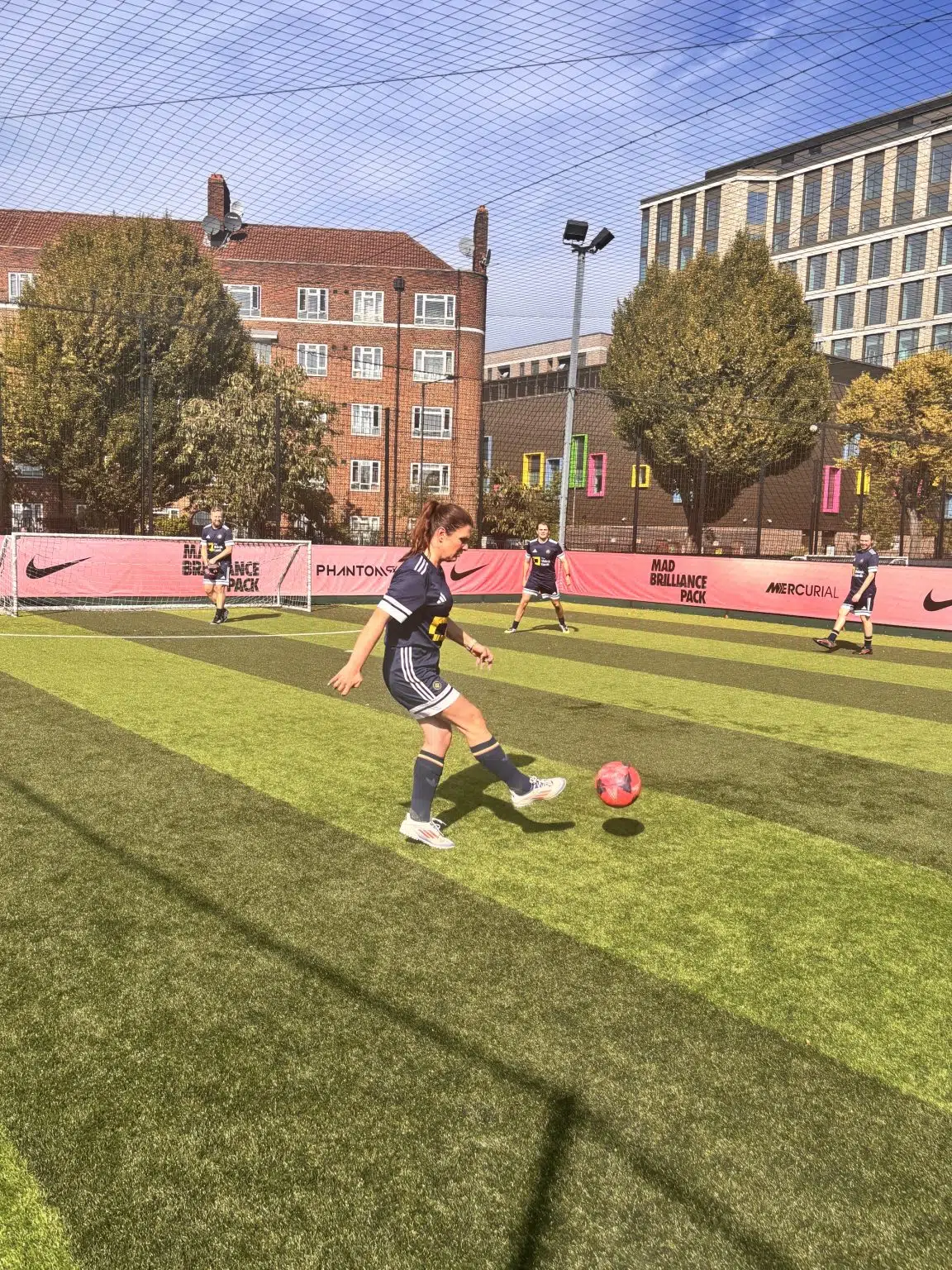 Dragana kicking football